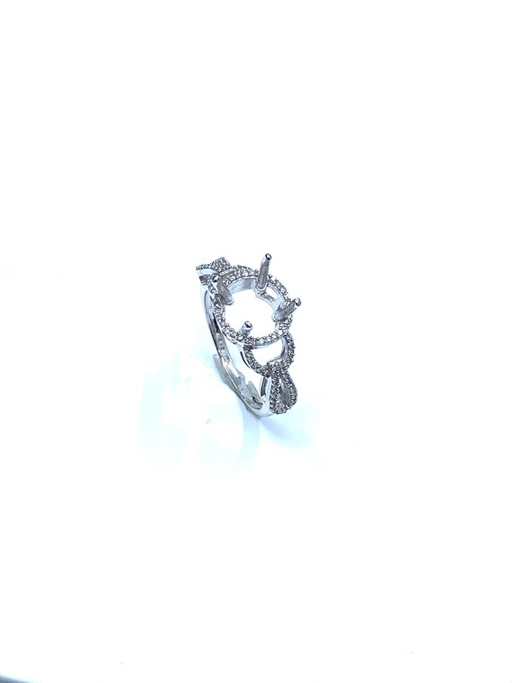 14 K White Gold Designer Diamond Semi-mount Engagement Ring with Built in Four Prongs on a Round Halo