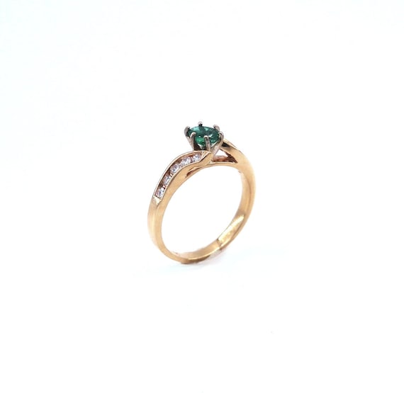 14 K Y Gold Bypass Style Ring featuring Oval Shaped Emerald, Gold, 3.3 grams, TW of Diamonds, 0.31 CT