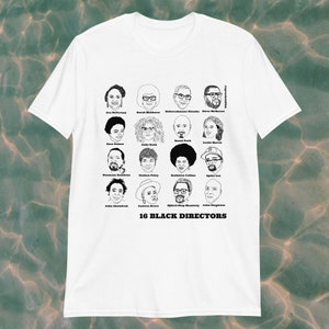 May include: A white t-shirt with a black and white illustration of 16 Black directors. The text "16 Black Directors" is printed below the illustrations.