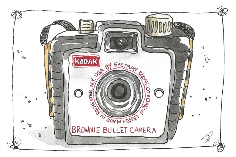 May include: Watercolor illustration of a vintage Kodak Brownie Bullet Camera. The camera is gray and white with a red Kodak logo. Text on the camera reads "Brownie Bullet Camera" and "Made in Rochester, N.Y., USA by Eastman Kodak Co. Dakon Lens."