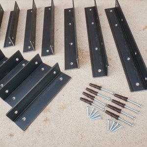 May include: A set of 10 black metal shelf brackets with 4 brown plastic anchors and 12 silver screws. The brackets are in various sizes and shapes.