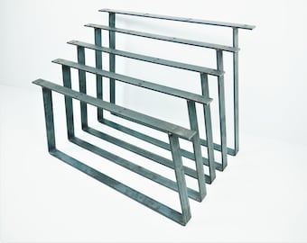 May include: Set of five metal table legs in various sizes. The legs are made of steel and have a raw, industrial finish.