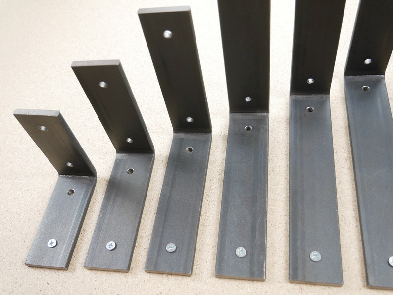 May include: A set of six dark gray metal shelf brackets in varying sizes. Each L-shaped bracket has pre-drilled holes for mounting and includes a silver screw. The brackets are designed for supporting shelves and are made of sturdy metal.