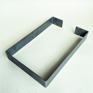 May include: A metal frame with a rectangular shape. The frame is made of a single piece of metal that is bent into a rectangle. The frame is open on one side.