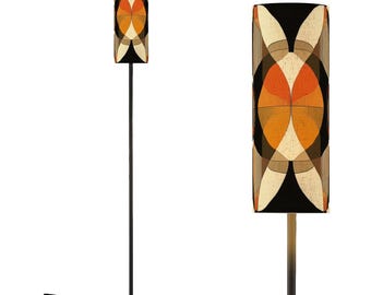 May include: A black floor lamp with a tall, slender stem and a cylindrical lampshade featuring a geometric pattern in shades of orange, brown, and beige.