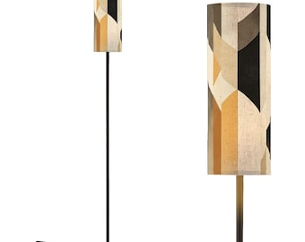May include: A tall, black floor lamp with a cylindrical lampshade. The lampshade features a geometric pattern in shades of beige, yellow, and black. The lamp has a round base and a foot switch on the cord.