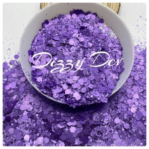 May include: Purple iridescent glitter in a white bowl. The glitter is in various sizes and shapes. The text "Dizzy Dev" is visible in the center of the image.