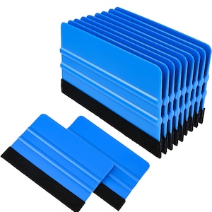 May include: A collection of blue plastic squeegees with black felt edges. The squeegees are arranged in a stack and also lying flat. These tools are commonly used for applying vinyl or window tint.