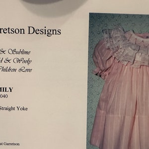 May include: A vintage children's dress pattern, featuring a pink striped dress with a white lace collar and sleeves. The pattern is labeled "EMILY #040" and includes the text "Elegant & Sublime To Wild & Wooly Designs Children Love."