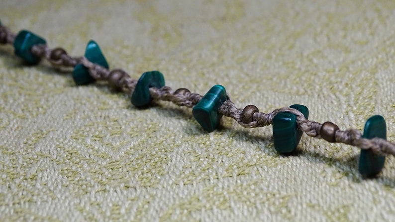 handmade macrame foot chain with semiprecious stone shards and om sign in beigelight brown anklet