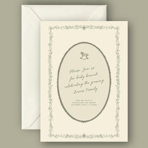 May include: Cream-colored baby brunch invitation with an oval frame and floral border. The text reads "Please Join us for baby brunch celebrating the growing Barns Family." Includes address and time details.