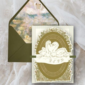 May include: An invitation suite featuring a swan design. The invitation card has a cream background with an oval frame and a swan illustration. The envelope is olive green with a painting of swans on the inside. The text "R.S.V.P." is visible.
