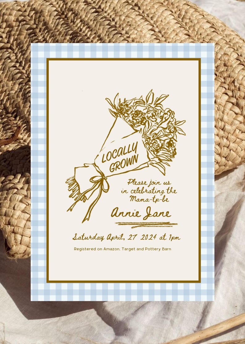 May include: An invitation with a light blue and white gingham border. The invitation features a gold illustration of a bouquet of flowers with the words "Locally Grown". Text on the invitation reads "Please join us in celebrating the Mama-to-be Annie Jane".