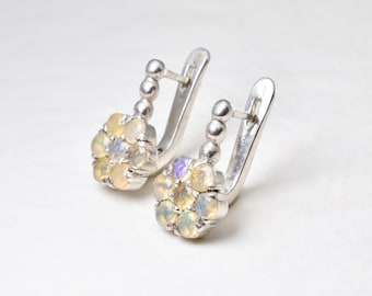 May include: A pair of silver earrings with a cluster of opal and amethyst gemstones in a flower shape.