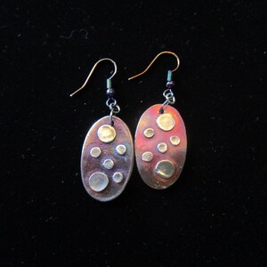 Shiny silver dots on  a colorful oval dangle   Item---S278