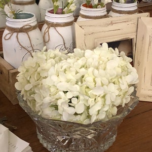 White roses in crystal bowl faux water