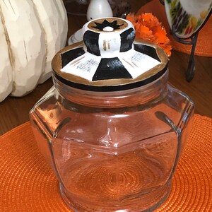 Glass octagon canister painted lid Black and white with gold accents width 7” height with lid 8” no lid 6”