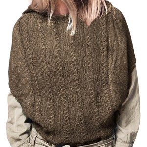 May include: A brown knitted poncho with a cable knit pattern.