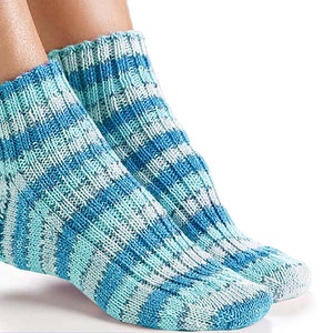 May include: A pair of blue and white striped socks with a ribbed texture.
