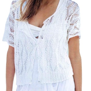 May include: White crochet cardigan with a button fastening and short sleeves.
