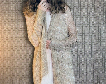 May include: A beige open-front cardigan with a delicate knit pattern. The cardigan is made of a soft, lightweight fabric and has a relaxed fit.