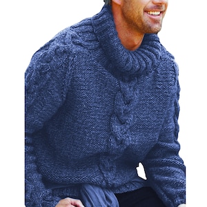 May include: A navy blue cable-knit jumper with a high, rolled collar. The jumper features a textured pattern on the front and sleeves. The model is wearing the jumper and smiling.