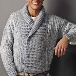 May include: A light grey knitted cardigan with a wide collar, double breasted closure, and four silver buttons.