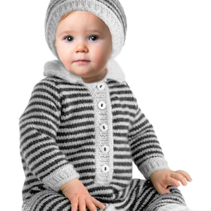 May include: A baby wearing a gray and white striped knit jumpsuit and matching hat. The jumpsuit has a button-up front and attached feet. The baby is sitting and looking at the camera.