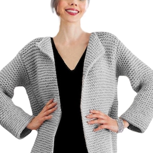 May include: A gray knitted cardigan with a V-neck and long sleeves. The cardigan is made of a soft, chunky yarn and has a relaxed fit.