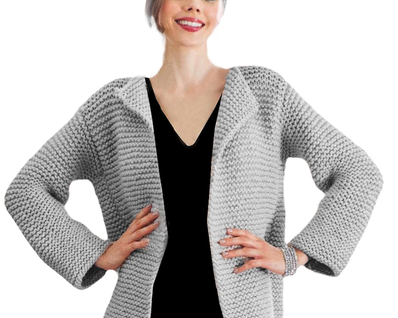 May include: A gray knitted cardigan with a V-neck and long sleeves. The cardigan is made of a soft, chunky yarn and has a relaxed fit.