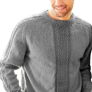 May include: A grey crew neck sweater with cable knit detailing down the centre and on the sleeves. The sweater has a textured appearance and a classic design. The neckline and shoulders feature a ribbed pattern. This knitwear is suitable for cooler weather.