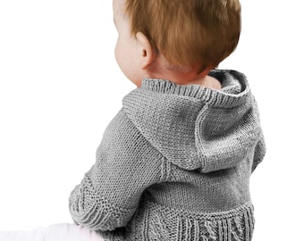 May include: A gray knitted baby hoodie with a hood and cable knit detailing on the lower back. The baby is wearing white pants. The hoodie is made of a soft, textured yarn.