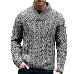 May include: A gray cable knit sweater with a wide, folded collar. The sweater has a chevron pattern.