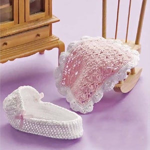 May include: A white crocheted baby bassinet with a pink ribbon and a pink crocheted baby blanket.