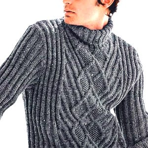May include: A grey turtleneck jumper with a textured knit pattern. The jumper features a ribbed design on the sleeves and body, with a diamond-shaped cable knit detail across the chest.