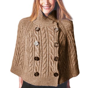 May include: A tan cable-knit cape sweater with a double-breasted design. The sweater features a high, ribbed collar and is fastened with eight dark brown buttons. The sleeves are short, and the overall style is classic and warm.