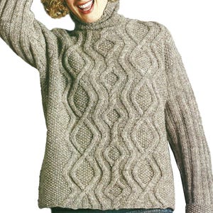 May include: A light brown cable-knit turtleneck sweater. The sweater features a textured diamond pattern on the front and sleeves. The sleeves have ribbed cuffs. The sweater is made of a soft, warm material, perfect for cold weather.