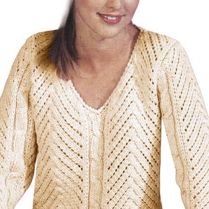 May include: A cream-colored knitted sweater with a V-neck and a chevron pattern.