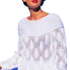 May include: A white, open-weave sweater with a boat neck and long sleeves. The sweater features a textured, ribbed design around the neckline and a diamond-shaped openwork pattern on the body. The sleeves also have an openwork design.