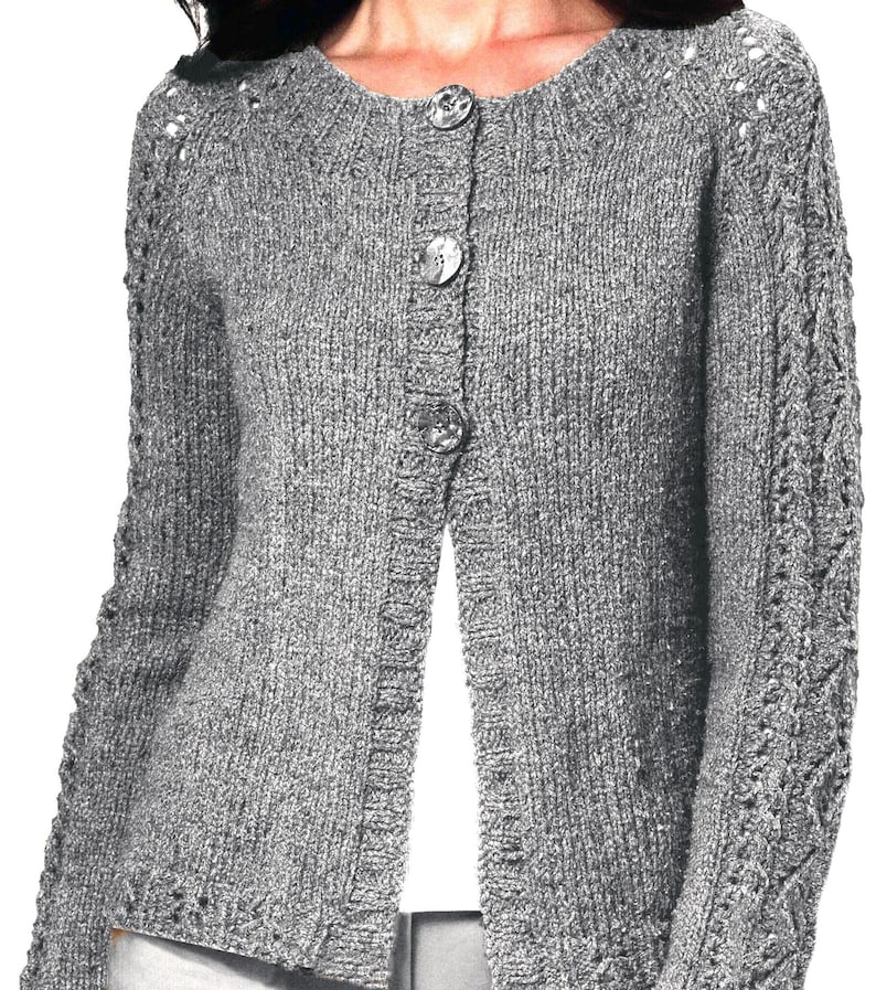 May include: A gray knitted cardigan with a button closure and a cable knit pattern on the sleeves.