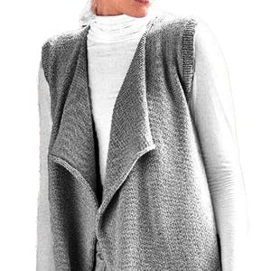 May include: A sleeveless gray knit vest featuring an open front design with a draped collar and a textured fabric finish. The garment is worn over a white long-sleeved shirt, showcasing a layered look with ribbed armhole edges and a straight hem.
