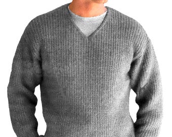 May include: A gray, ribbed-knit sweater with a V-neck. The sweater is a medium gray color and appears to be made of a thick, warm material. The sweater is worn over a light gray undershirt.
