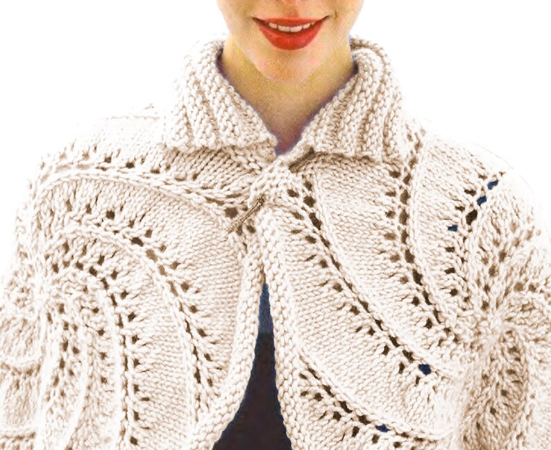 May include: Cream-coloured knitted bolero with a decorative openwork pattern. The bolero features a shawl collar and is fastened with a metal clasp. The knitwear has a textured appearance and is suitable for layering.