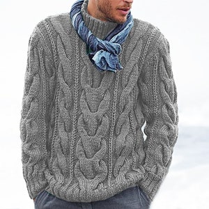 May include: A gray cable knit sweater with a long sleeve and a mock neck. The sweater is made of a soft, comfortable material and has a relaxed fit.