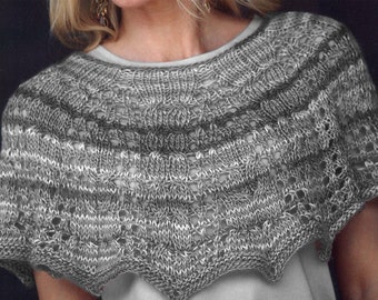 May include: A gray and white knitted shawl with a delicate lace pattern.