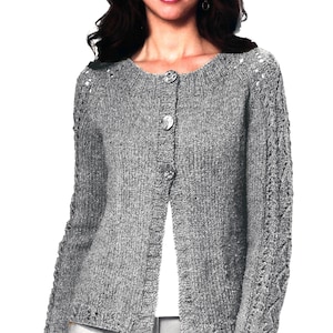 May include: A gray knitted cardigan with a button closure and a cable knit design on the sleeves.