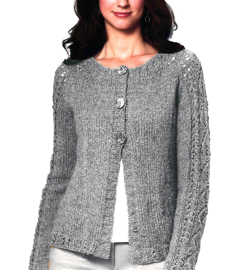 May include: A gray knitted cardigan with a button closure and a cable knit design on the sleeves.