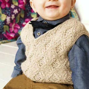 May include: A beige knitted waistcoat with a cable knit pattern and a V-neck. The waistcoat is worn by a young child with a blue shirt and brown trousers.