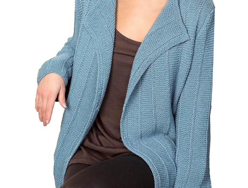 May include: A light blue cardigan with a long, open front and a ribbed texture. The cardigan is made of a soft, comfortable material and has a relaxed fit.