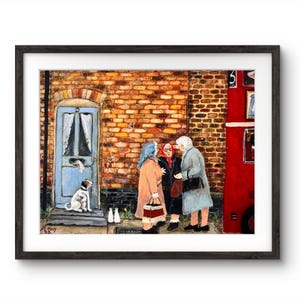 May include: A framed art print depicting a street scene with three women conversing near a red bus. A dog sits by a blue door. The artwork features a brick building and a whimsical style.